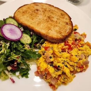 JustEgg scramble with veggies, side salad, and sourdough toast