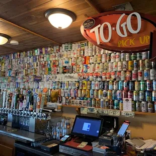 a bar with a lot of cans on the wall