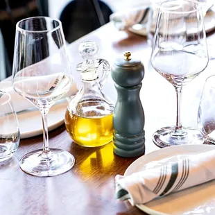 a table setting with wine glasses, plates and utensils