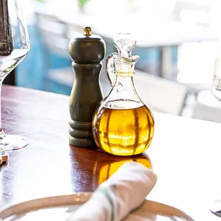 a bottle of olive oil and a glass of wine