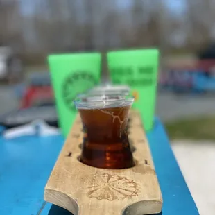 a beer in a glass on a paddle