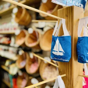 a variety of bags hanging on a wooden pole