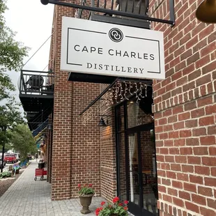 a brick building with a sign that reads cape charles distillery