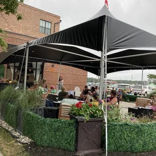 a group of people sitting under a tent