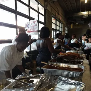 In line for Jollof and tasty dishes.