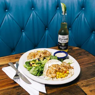 a plate of food and a bottle of beer