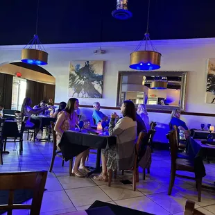 people sitting at tables in a restaurant