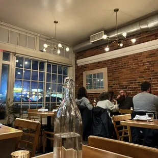 people sitting at tables in a restaurant