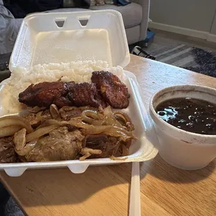 Fried pork and chicken adobo with white rice and black beans