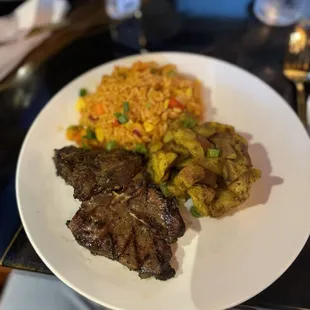 T-bone lamb with curry potatoes and jollof rice.