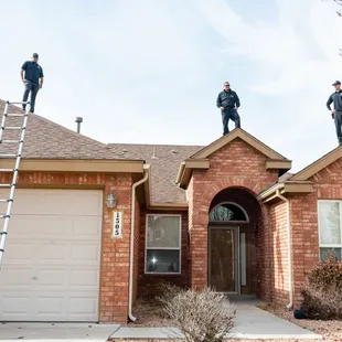 three men on a roof