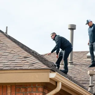 two men working on a roof