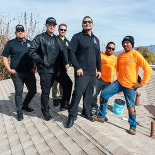 a group of men standing on a roof