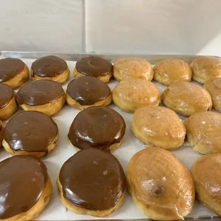 a tray of chocolate covered doughnuts