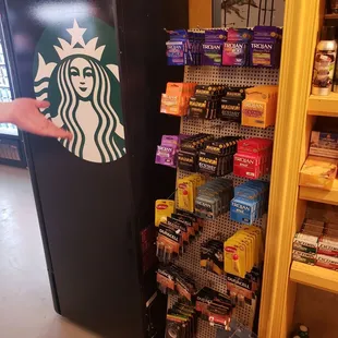 a hand reaching for a starbucks beverage