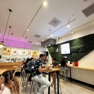people sitting at tables in a restaurant