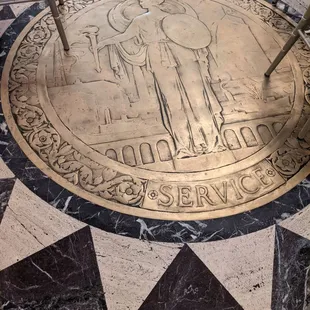 Love the wear on this brass floor medallion. Almost 100 years of foot traffic.