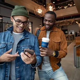 two men looking at their phones