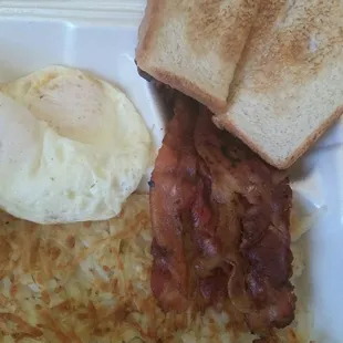 Eggs over easy, bacon, toast, and hash browns - $3.90