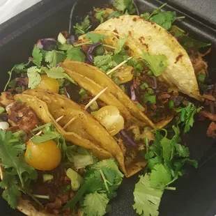 Pork belly tacos $8 Roasted pork belly purple cabbage yellow tomatoes and green onion. And toasted coconut!