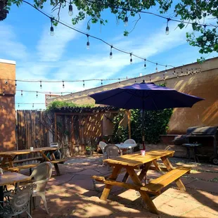 a patio with tables and umbrellas