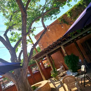 a patio with tables and umbrellas