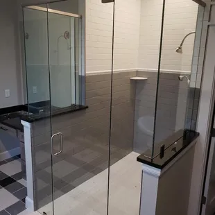 Frameless glass shower enclosure