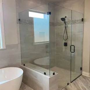 Frameless glass shower enclosure