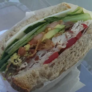 Turkey, provolone, lettuce, tomato, bacon, roasted red pepper, avocado on wheat. Excellent!