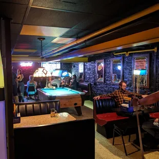 Busy pool table and lots of TV&apos;s.