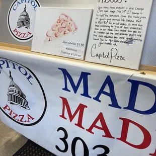 a sign for mad mad pizza