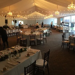 Beautiful wedding tent! String lights paired with crystal and chrome chandalier's. Call to customize your next tent rental !(916)383-1828