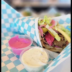 Lamb and beef pita wrap with Beet Lebni and tzatziki sauce on the side