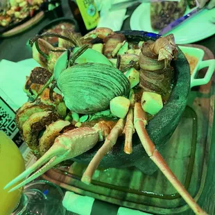 Molcajete with all seafood  Combination fajitas in the back. Both bland sadly !