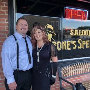 a man and woman standing in front of a store