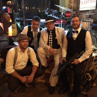 three men in pinstripes posing for a picture