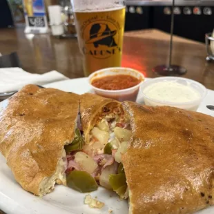 Food was delicious Canadian bacon, bacon, jalapeño, pineapple calzone And an ice cold space dust