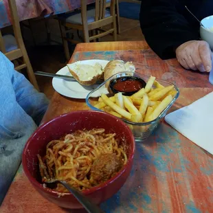 Spaghetti and meatballs with fries.