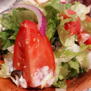 Side Salad with lettuce, tomato, black olives, purple onion, and their home Italian dressing with parmesan cheese