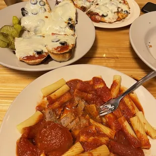 a plate of pasta and a plate of pizza