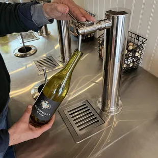 a man pouring a bottle of wine