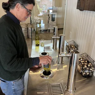 a man pouring a glass of wine