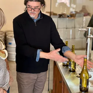a woman pouring a glass of wine