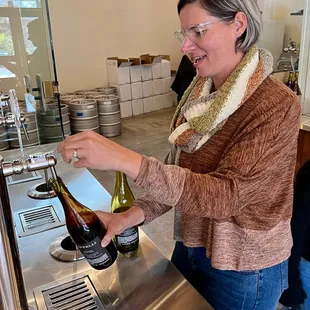 a woman pouring a glass of wine