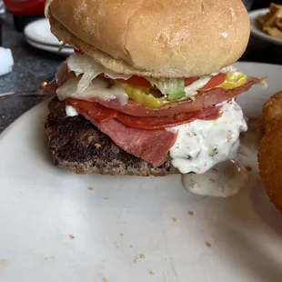 Same Toman burger - the huge patty is hanging over the bun!