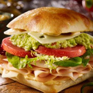 a ham sandwich with lettuce, tomato, and cheese