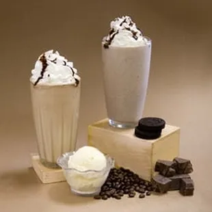 two milkshakes with whipped cream and chocolate