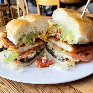 Fiesta Torta: chicken Milanese, refried black beans, lettuce, tomato, guacamole, corn relish, Flamin&apos; Hot Cheetos
