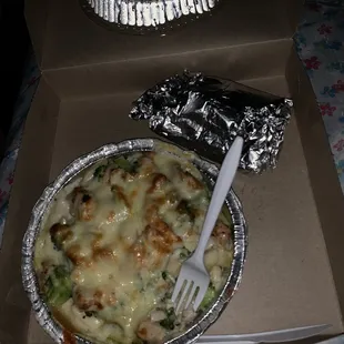 a pizza in a box with a fork