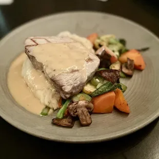 Oak-grilled ahi tuna with citrus beurre blanc, mashed potatoes, and grilled vegetables